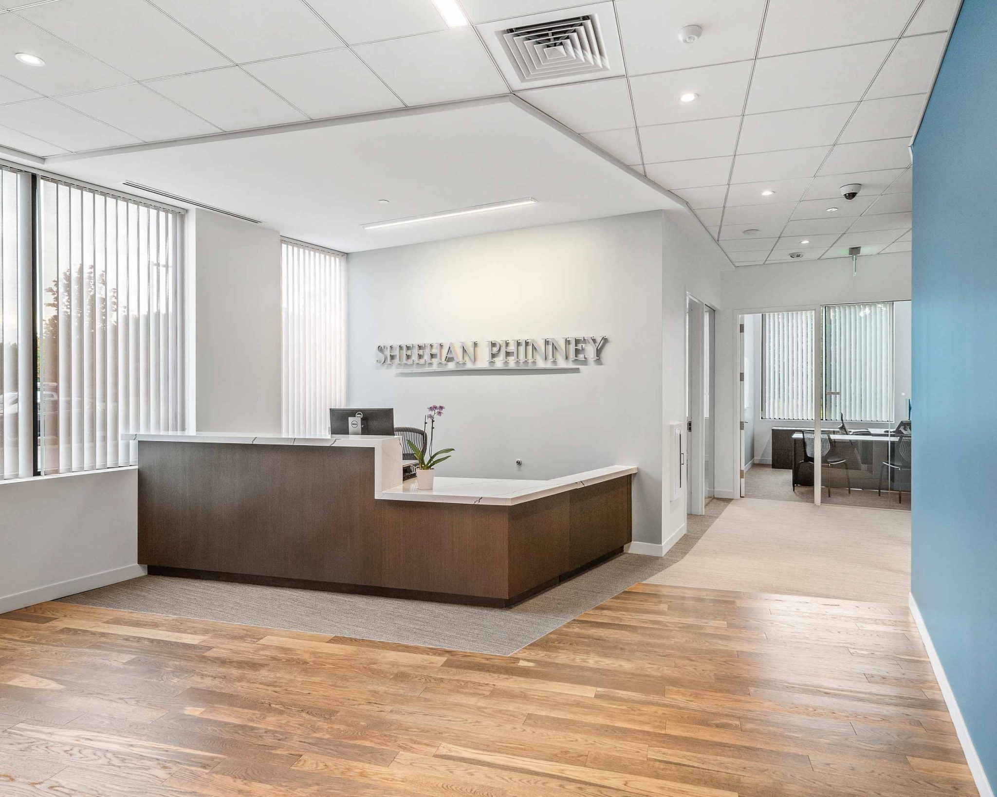 A view of the Sheehan Phinney sign behind a wood reception desk,